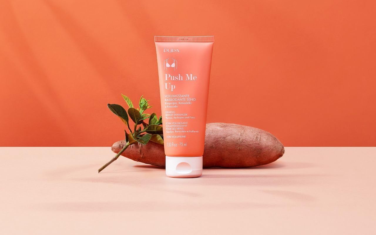 Tubo rosa con tappo bianco. Testo: Push Me Up, Fluido Volumizzante Rassodante Seno. Accanto: ramo e patata dolce.