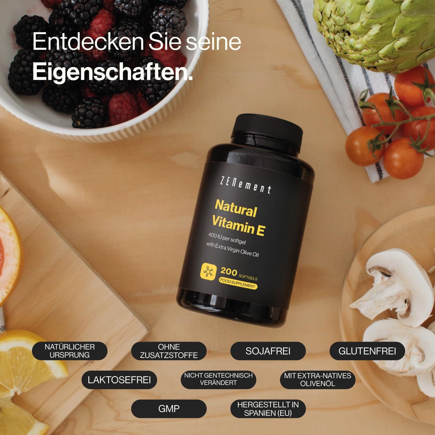 Flacone nero con softgel. Scritta: Natural Vitamin E, 200 softgel. Con olio d'oliva. Etichette aggiuntive.