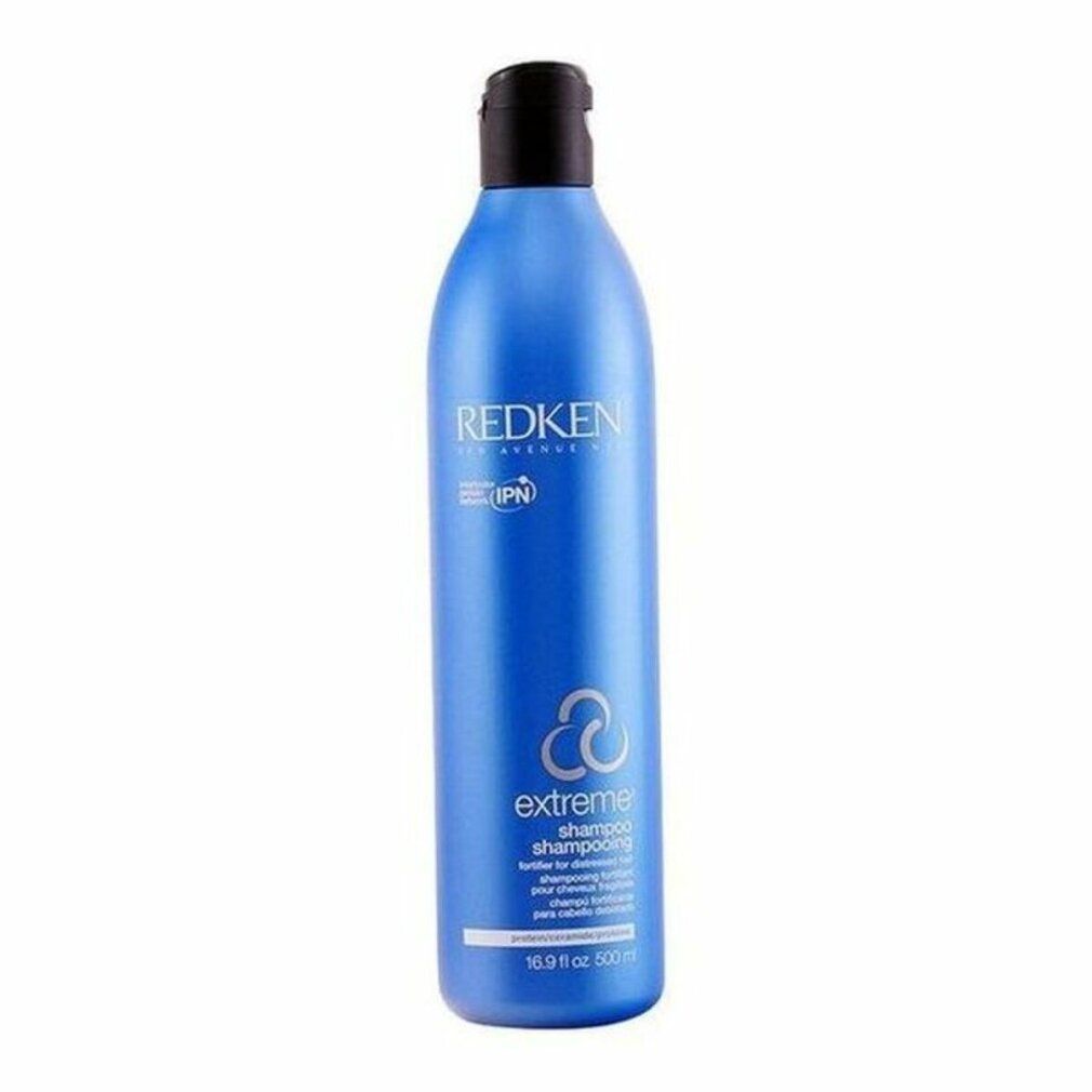 Flacone di shampoo blu con tappo nero. Scritta: Redken Extreme Shampoo. Contiene IPN. Per capelli danneggiati.