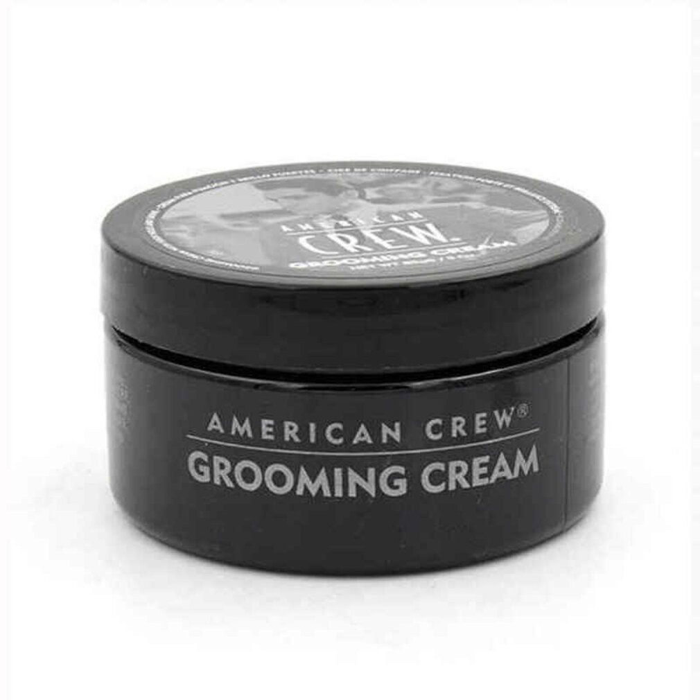 Barattolo nero American Crew Grooming Cream. Testo bianco sul contenitore. Coperchio con immagine e testo.