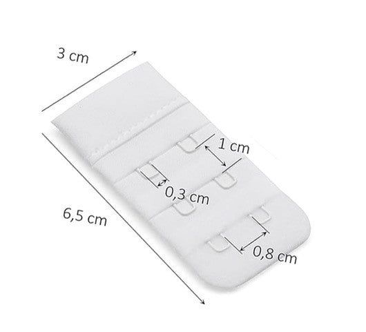 Prolunga reggiseno bianca con tre occhielli. Dimensioni: 6,5 cm di lunghezza, 3 cm di larghezza. Occhielli 1 cm di altezza, 0,8 cm di larghezza.
