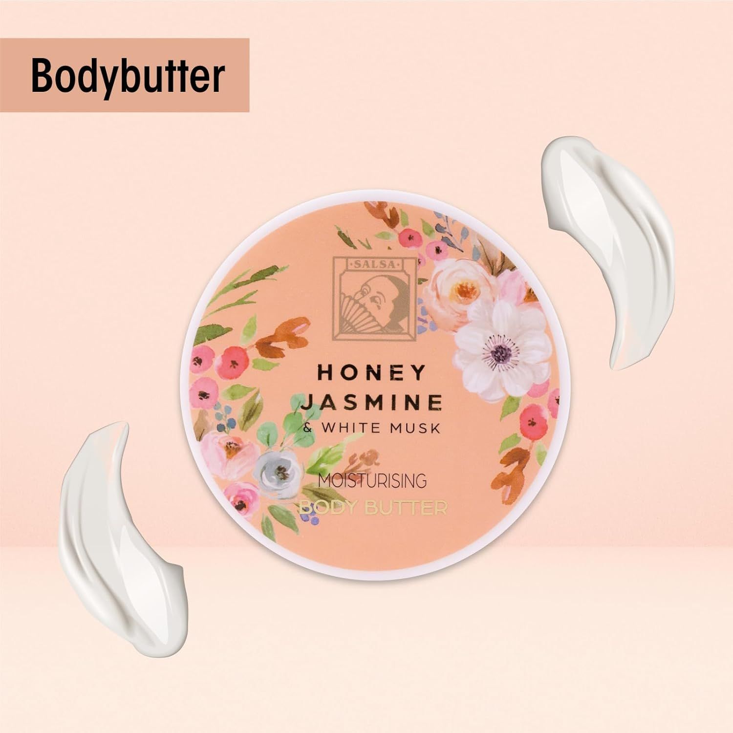 Barattolo rotondo di burro corpo con design floreale e scritte. Due macchie di crema accanto.