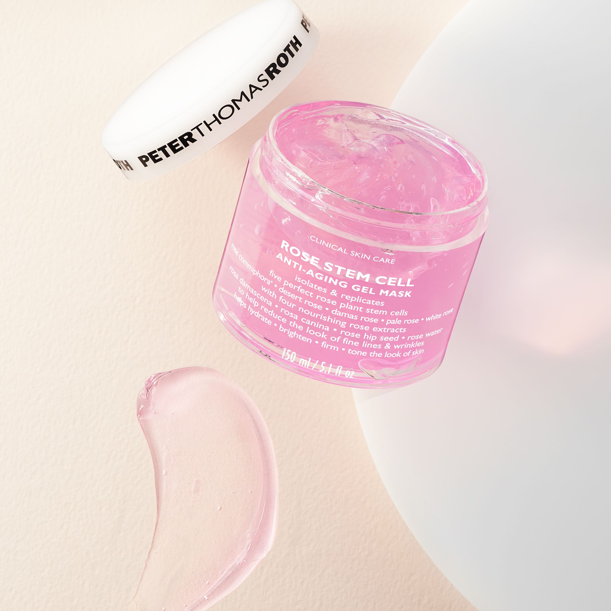 Peter Thomas Roth Rose Stem Cell Anti-Aging Gel Mask. Vasetto aperto, gel rosa. Coperchio accanto. Etichetta.