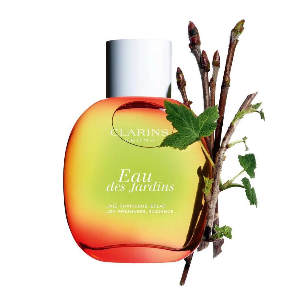 Flacone rotondo con tappo bianco. Scritta: Eau des Jardins, Clarins Aroma. Ramo con foglie.