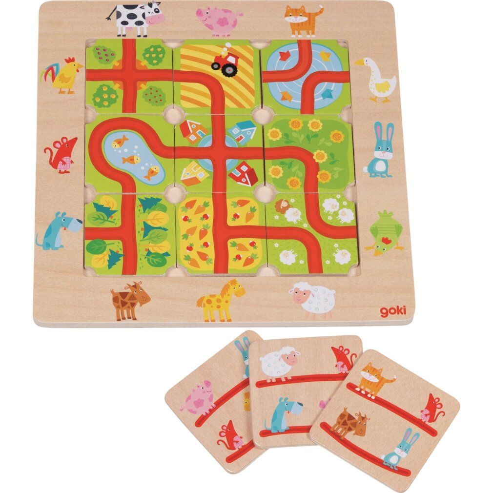 Puzzle in legno con animali e strade. Il tabellone è quadrato con pezzi di puzzle inseriti. Logo Goki in basso a destra.