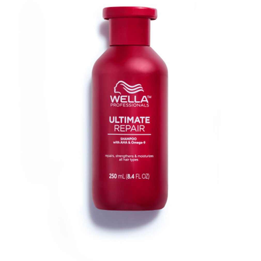 Flacone di shampoo rosso con logo bianco e scritta 'Ultimate Repair'. Testo: 'Shampoo con AHA & Omega-9'. Su sfondo bianco.