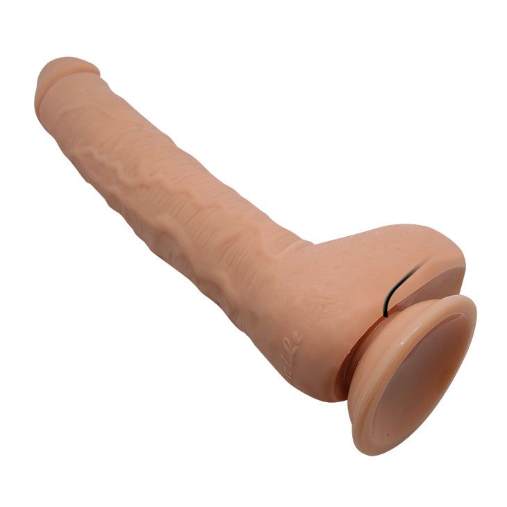 Dildo beige con fusto strutturato e base a ventosa.