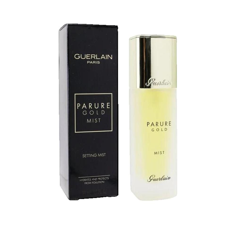 Flacone spray dorato e confezione nera. Scritta: Parure Gold Mist, Setting Mist, Guerlain.