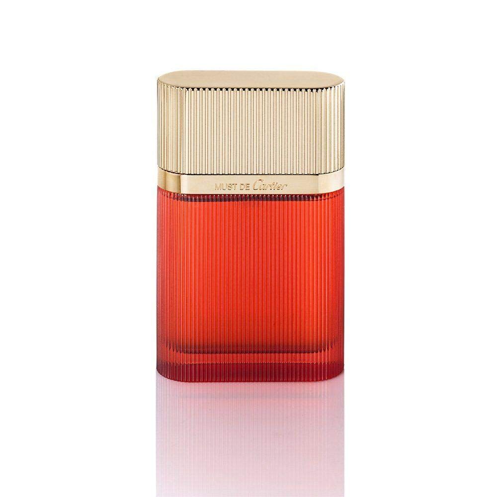 Flacone rosso con tappo dorato. Scanalature verticali. Scritta dorata: Must de Cartier.