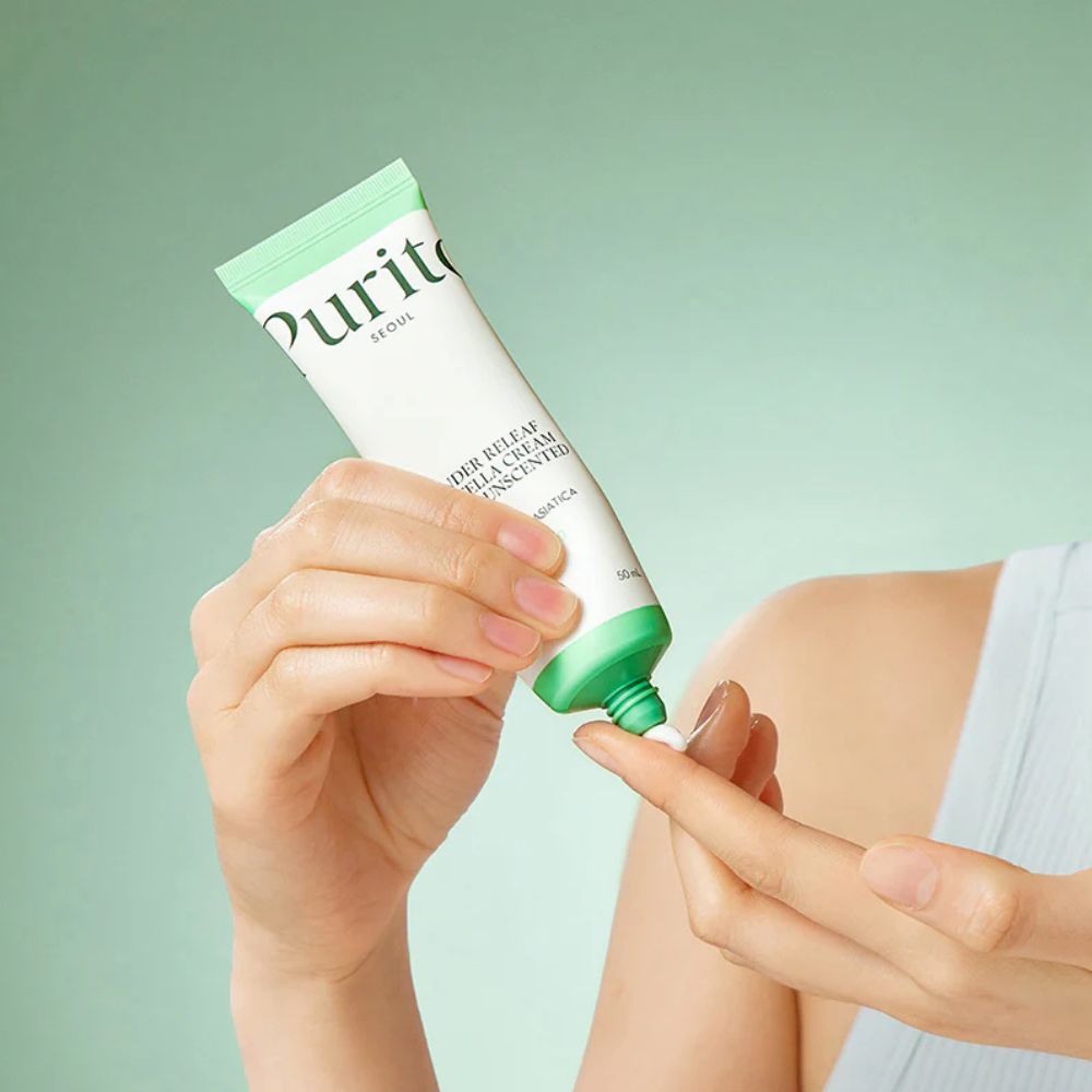 Mano applica PURITO Wonder Releaf Centella Cream Unscented sul dito.
