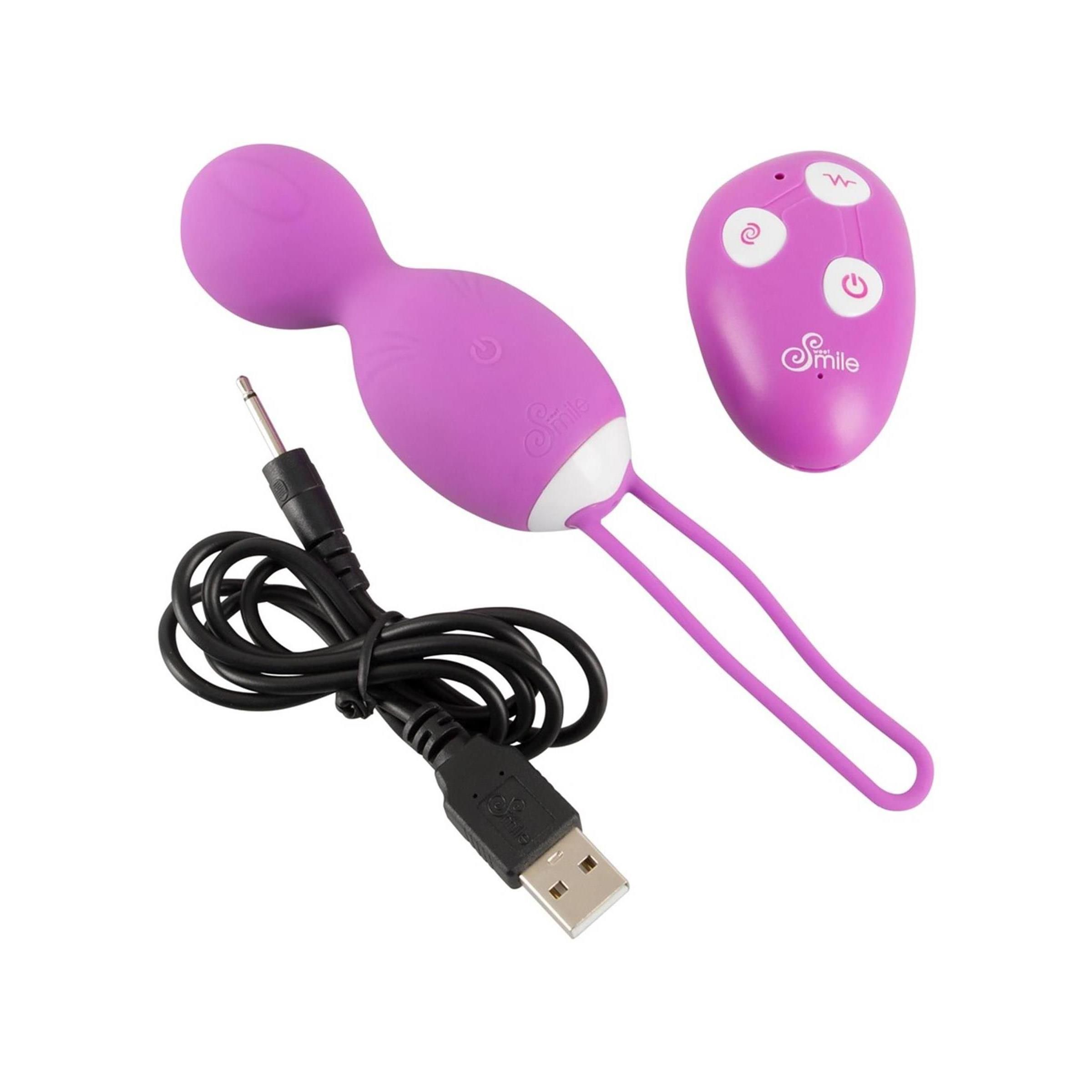 Love Balls viola con accento bianco e anello. Telecomando e cavo di ricarica accanto.