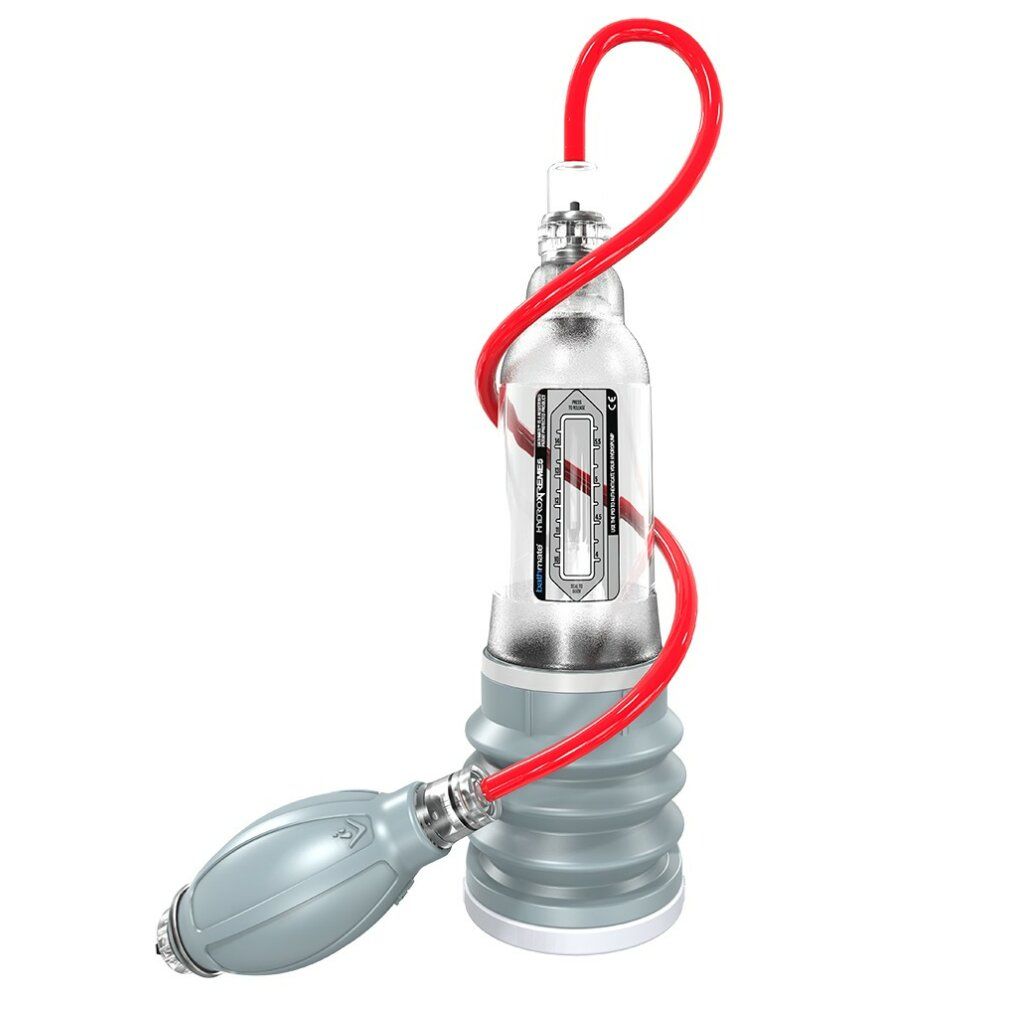 Dispositivo trasparente con tubo rosso e pompa. Base grigia con superficie scanalata.