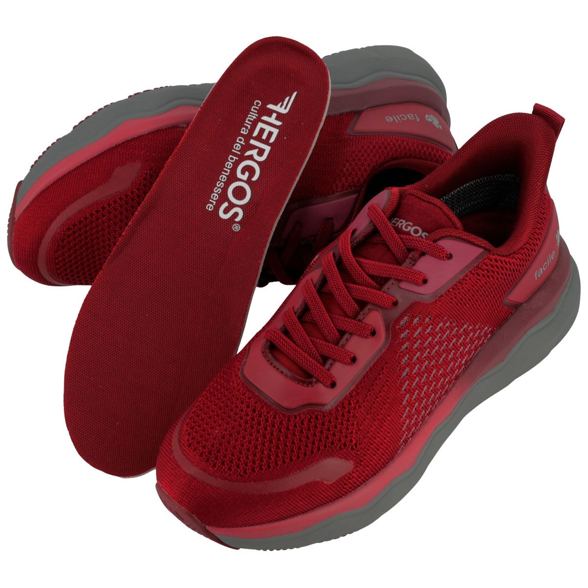 Scarpe sportive rosse con suola grigia e lacci. Una soletta interna è visibile.