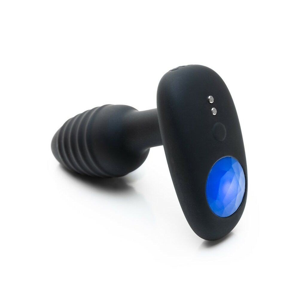 Prodotto benessere nero con estremità scanalata e pannello ovale con luce blu. Due pulsanti.
