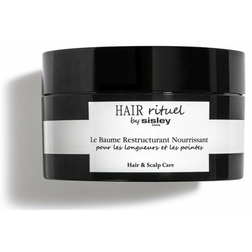 Vaso nero con etichetta bianca. Scritta: HAIR rituel by sisley PARIS. Le Baume Restructurant Nourrissant pour les longueurs et les pointes. Hair & Scalp Care.