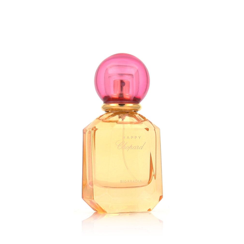 Flacone di profumo con tappo rosa e liquido giallo. Scritta Happy Chopard Bigaradia.