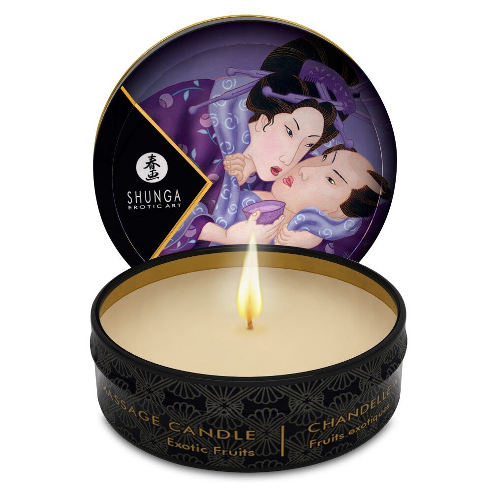 Candela da massaggio Shunga Libido/Exotic Fruits in scatola nera, fiamma accesa. Coperchio con arte erotica.