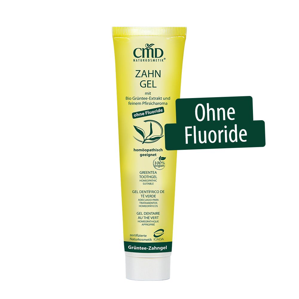 Tubo giallo di gel dentifricio CMD Naturkosmetik. Testo: Gel dentifricio con estratto di tè verde bio, senza fluoro. Adatto all'omeopatia. Adesivo verde: Senza fluoruro.