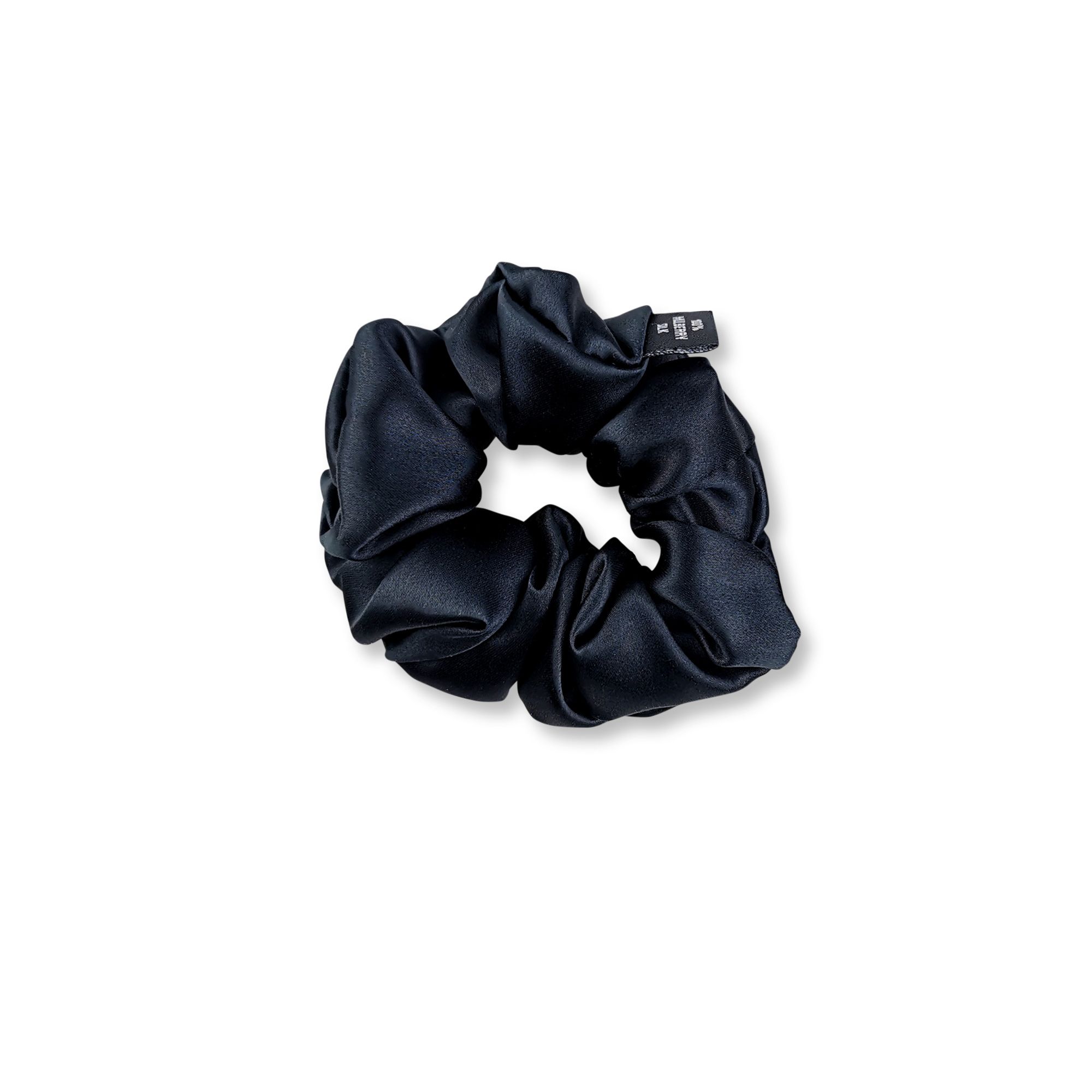 Scrunchie in seta nero con una piccola etichetta.