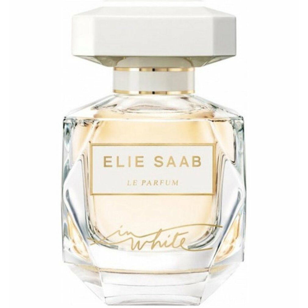 Flacone di profumo con tappo bianco ed etichetta dorata. Flacone in vetro trasparente con dettagli dorati e scritta.