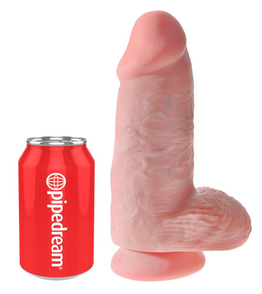 Dildo rosa accanto a una lattina rossa. Dildo con texture realistica e forma arrotondata.