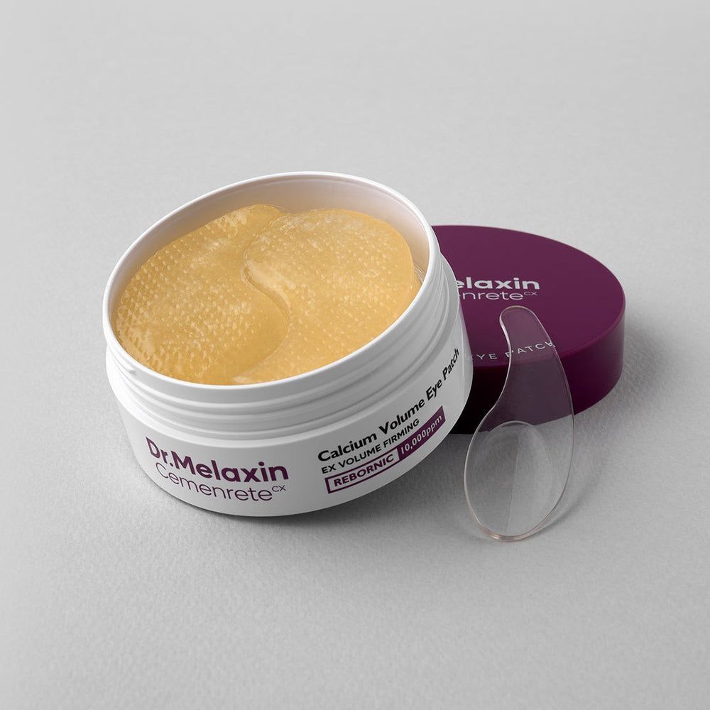 Dr. Melaxin Cemenrete Calcium Volume Eye Patch contenitore con patch occhi gialli e spatola.