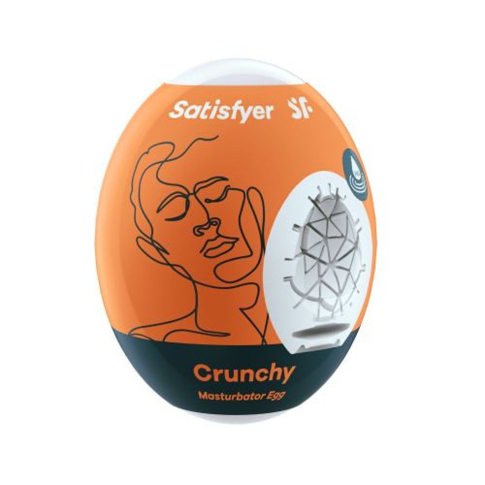 Prodotto a forma di uovo, arancione e bianco. Scritta "Satisfyer". Disegno di un volto. Testo "Crunchy Masturbator Egg".