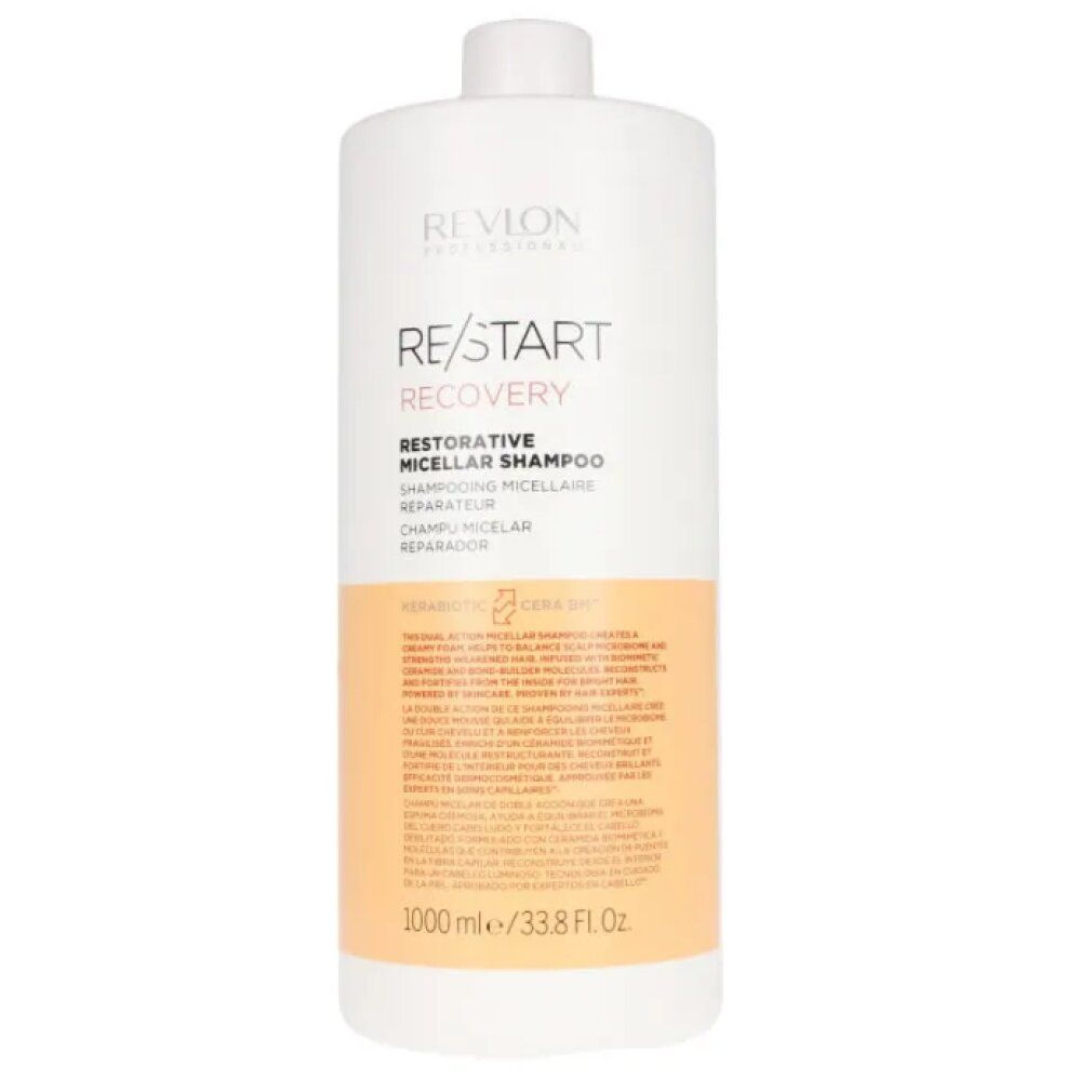 Flacone di shampoo bianco con scritta RE/START RECOVERY. Striscia arancione con testo. 1000 ml/33.8 Fl. Oz.