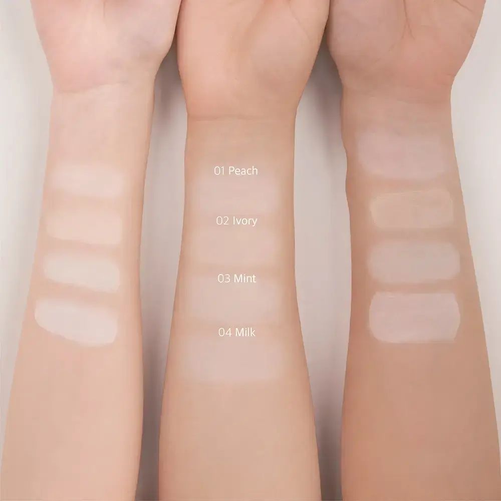 Tre braccia con primer per il trucco applicati. 01 Pesca, 02 Avorio, 03 Menta, 04 Latte. Sfumature.