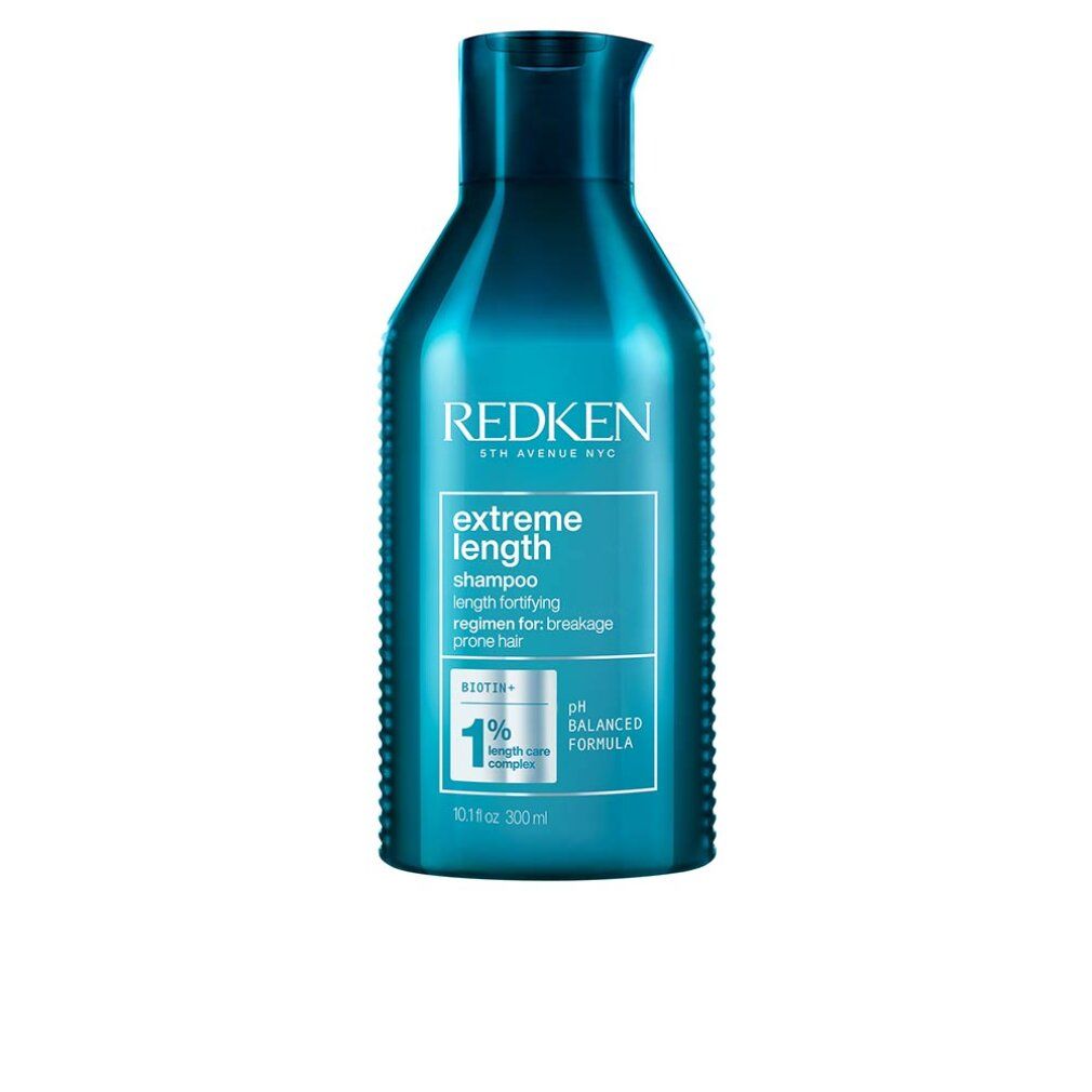 Flacone di shampoo blu trasparente. Scritta: Redken Extreme Length Shampoo. Con indicazione del pH.