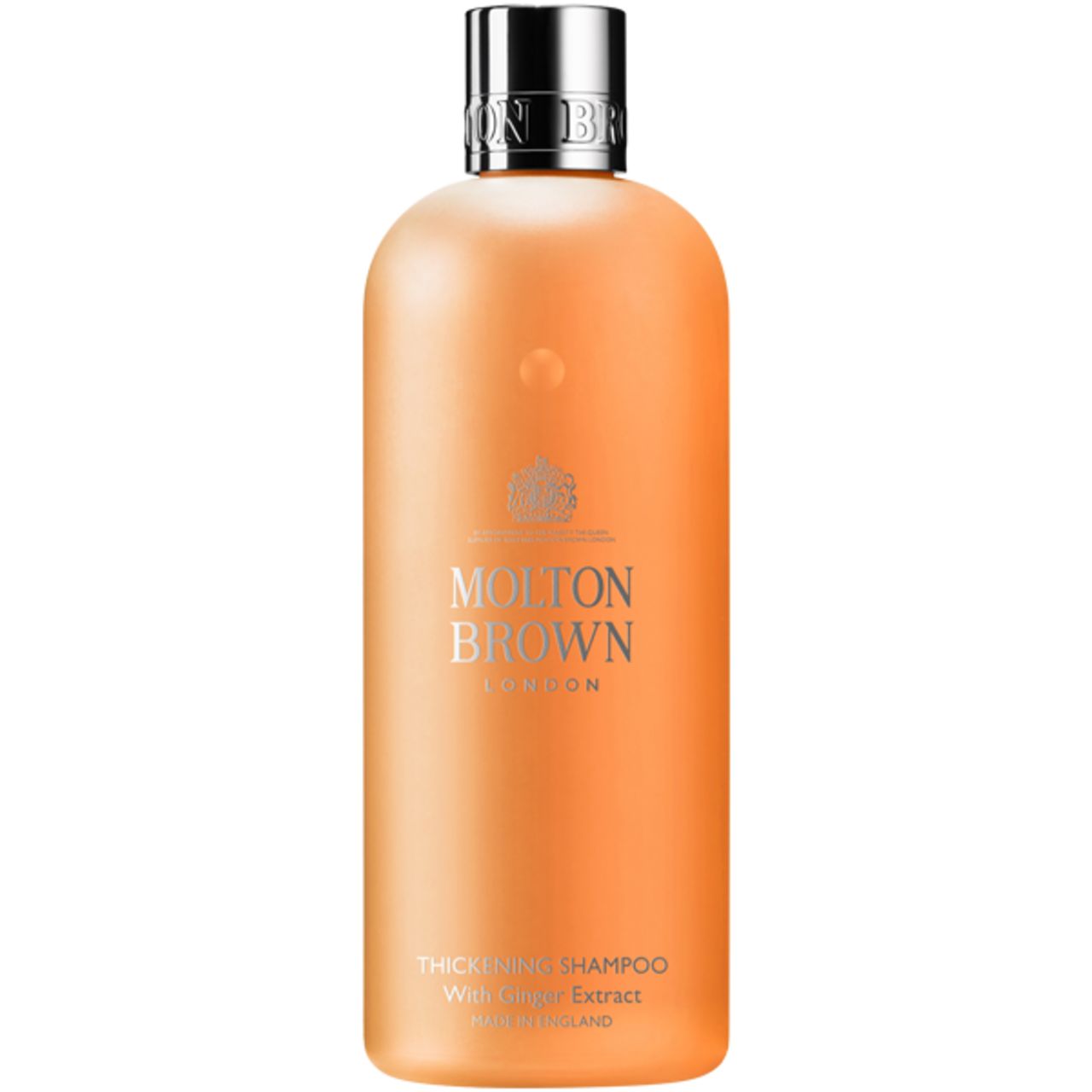 Flacone di shampoo arancione con tappo argentato. Scritta: Molton Brown London. Nome del prodotto: Thickening Shampoo with Ginger Extract.