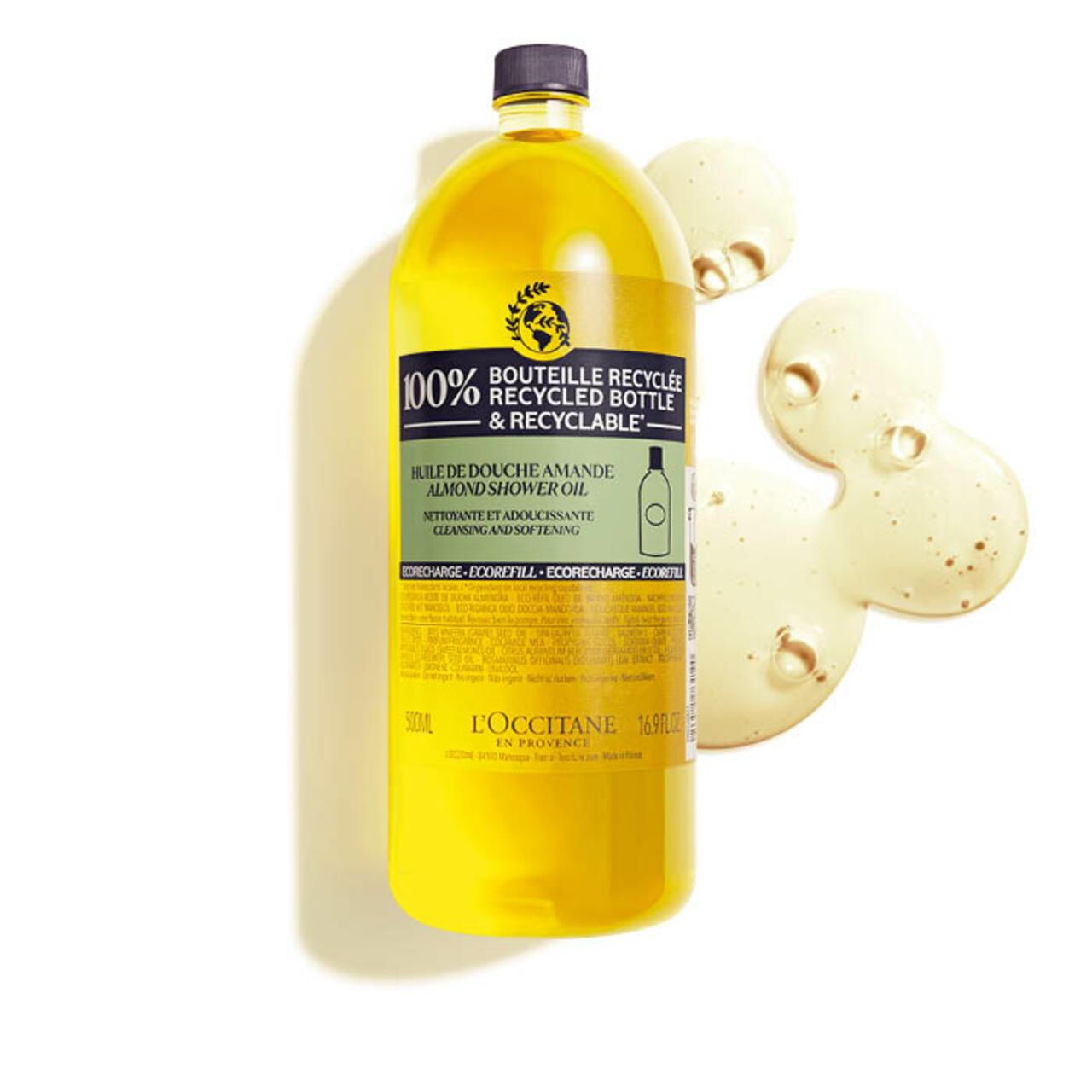 Flacone giallo di olio doccia alla mandorla. Scritta: bottiglia riciclata al 100%. L'Occitane.
