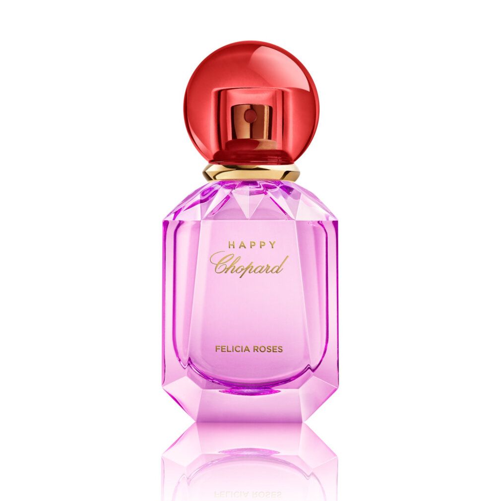 Flacone di profumo rosa con tappo rosso. Scritta HAPPY Chopard FELICIA ROSES. Flacone sfaccettato.