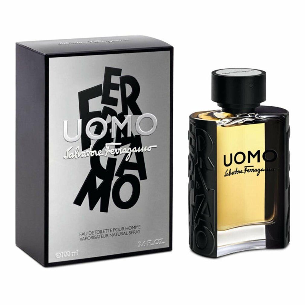 Flacone di profumo e scatola. Flacone con tappo nero e liquido dorato. Scritto: UOMO Salvatore Ferragamo.