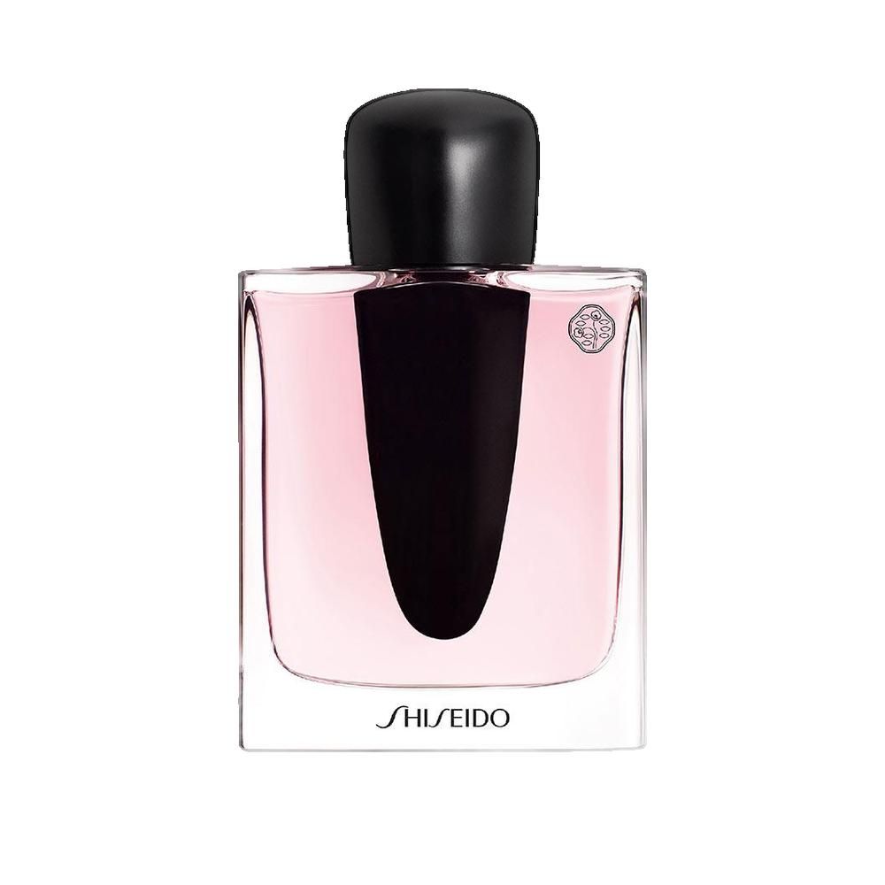 Flacone di profumo con tappo nero e liquido rosa. Scritta SHISEIDO.