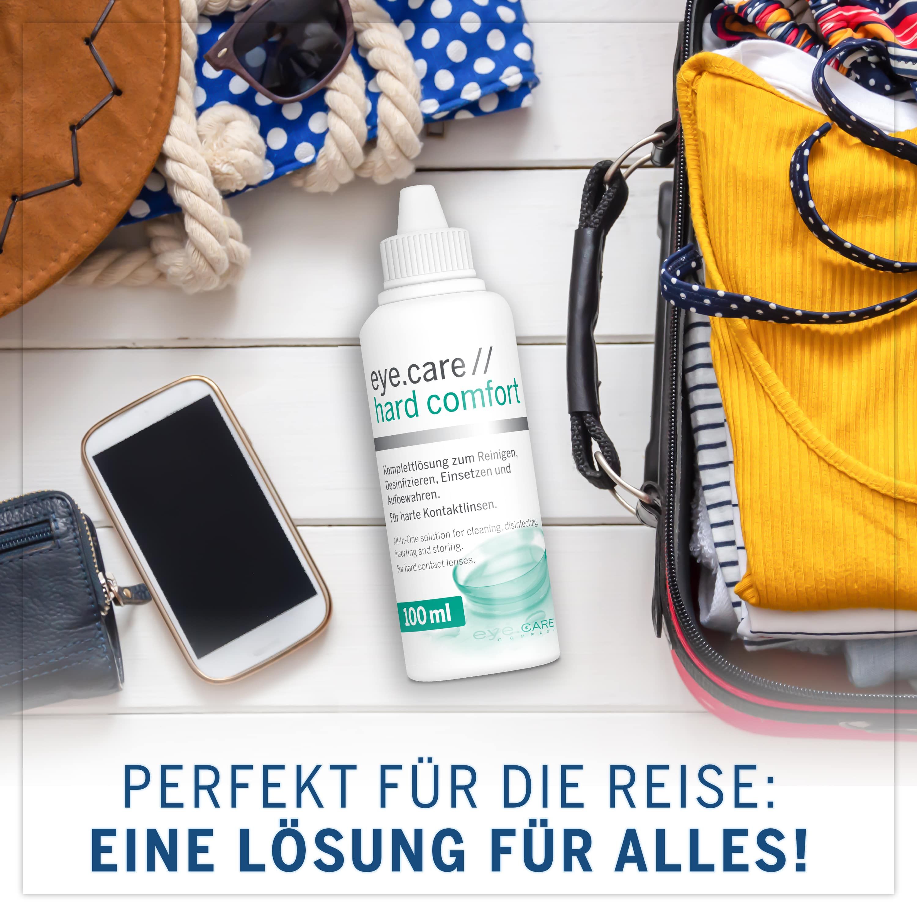 Flacone "eye.care // hard comfort" accanto a oggetti da viaggio. Testo: Perfetto per il viaggio: Una soluzione per tutto! 100 ml.