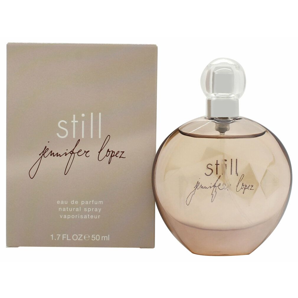 Flacone di profumo e scatola. Flacone rotondo, marrone chiaro. Scatola beige con scritta "still jennifer lopez".