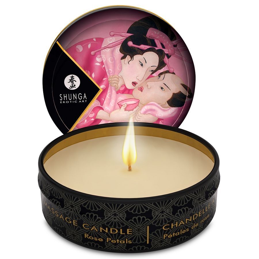 Candela da massaggio accesa in scatola nera con coperchio che mostra arte asiatica.