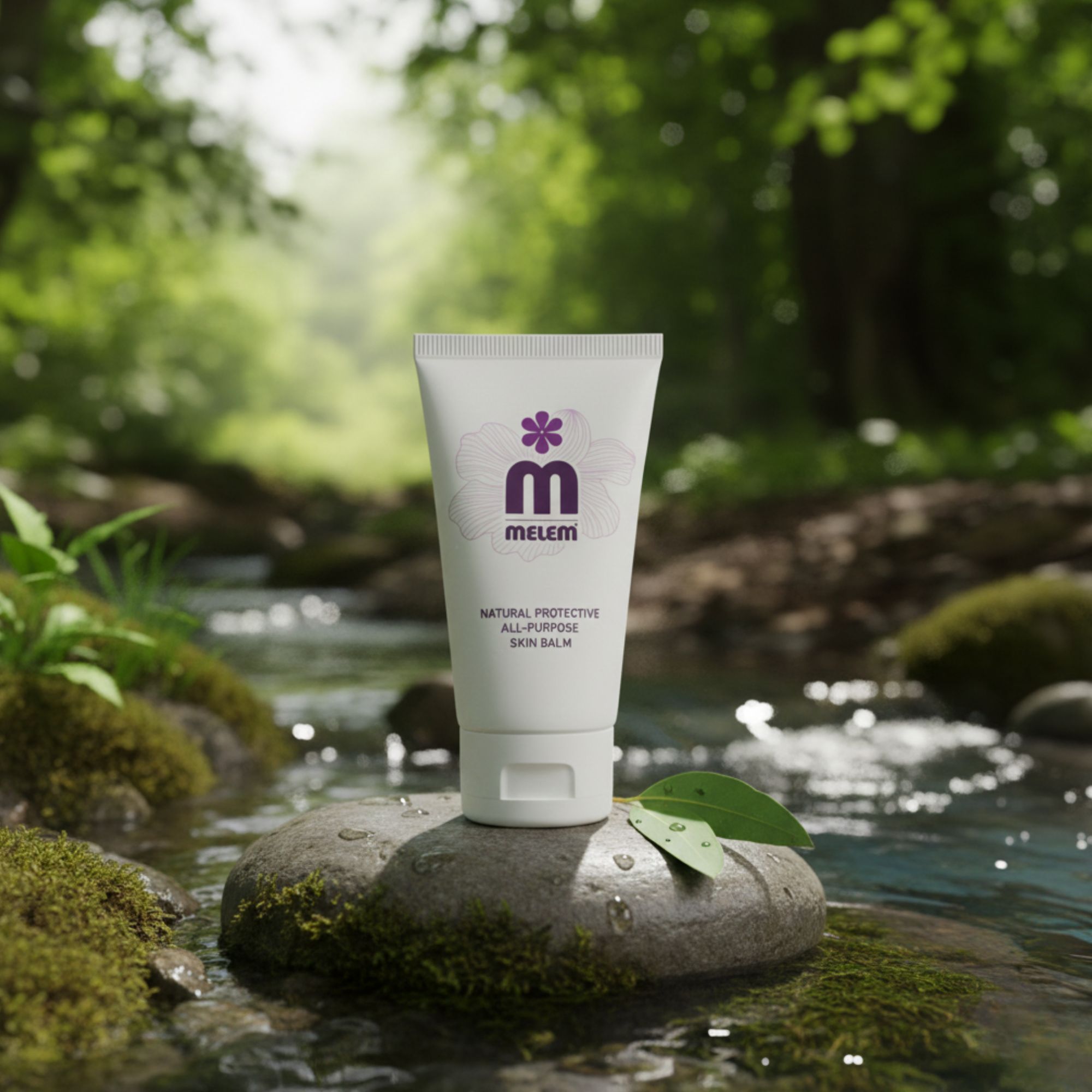 Tubetto bianco con logo viola e testo: Melem, Natural Protective All-Purpose Skin Balm. Posizionato su una pietra in un fiume.