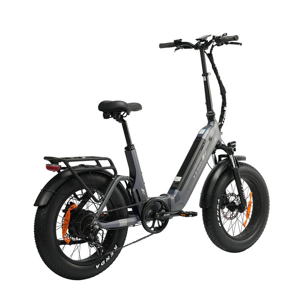 E-bike pieghevole grigia con pneumatici neri e dettagli arancioni. Dotata di portapacchi e freni a disco idraulici.