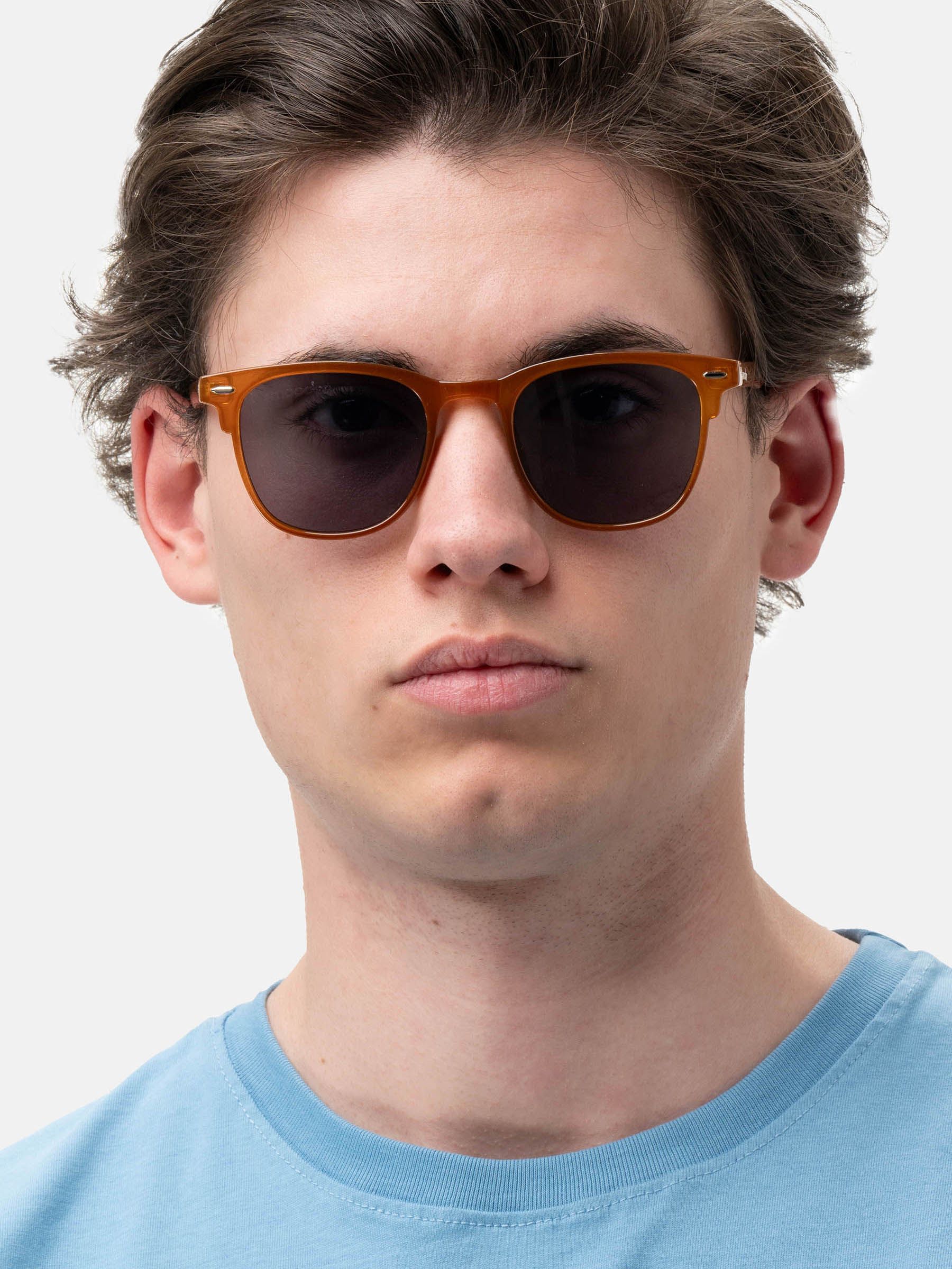 Uomo con occhiali da sole marroni e lenti scure. Primo piano.