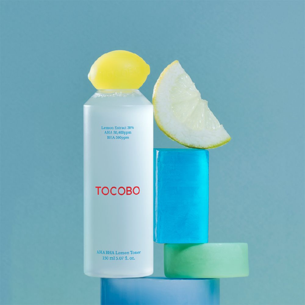 Flacone di toner al limone con tappo giallo e forme geometriche. Scritta TOCOBO. Testo: AHA BHA Lemon Toner, 150 ml.