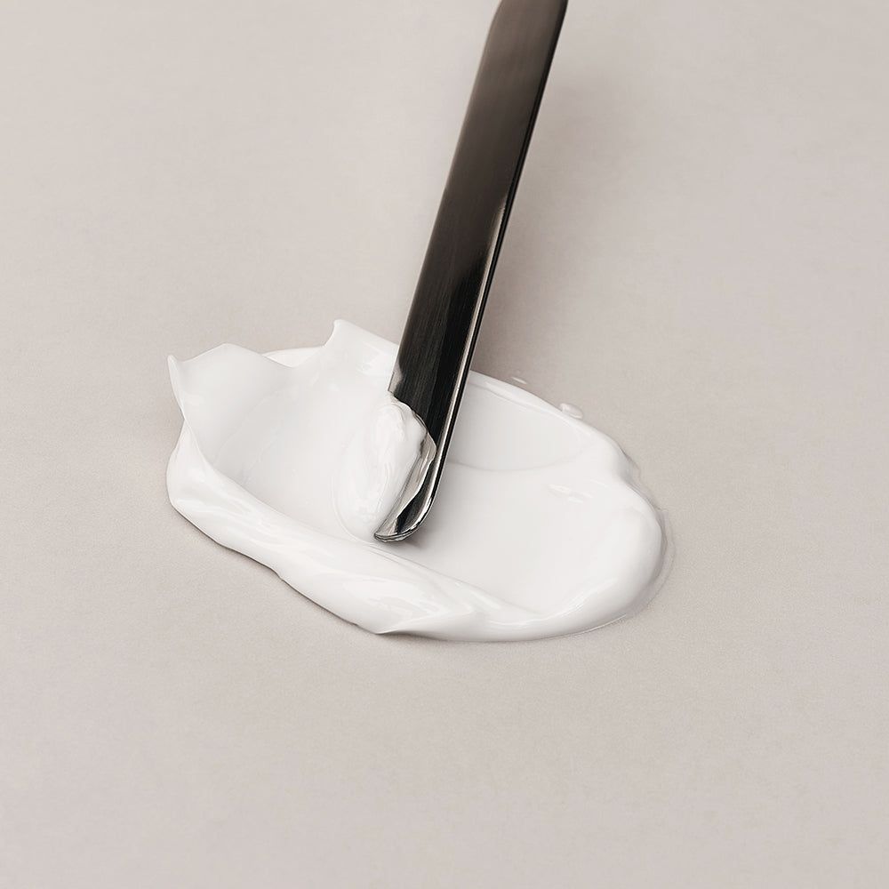 Un campione di crema barriera DR.REJU-ALL Advanced LC-Ceramide prelevato con una spatola.