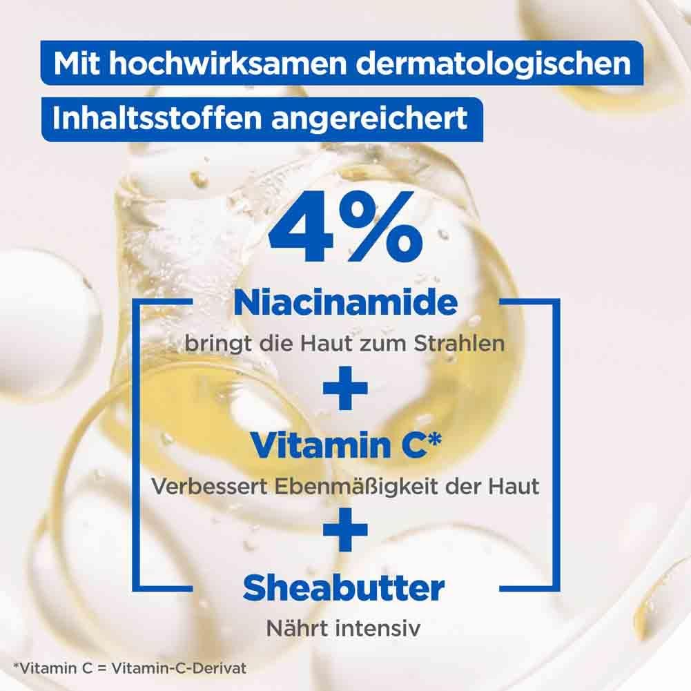 Primo piano di gocce di liquido. Testo: 4% Niacinamide, Vitamina C, Burro di karité.