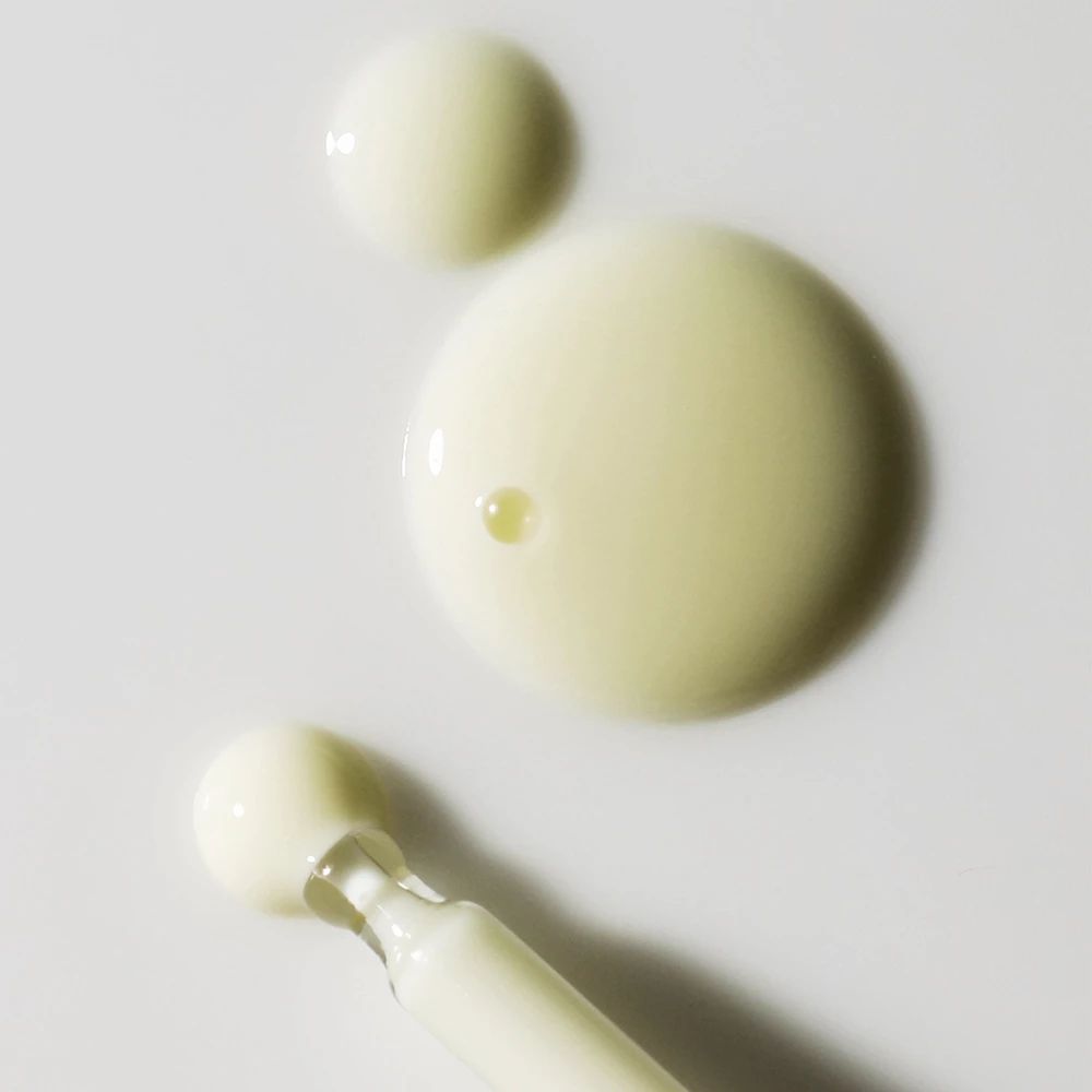 Gocce di siero e applicatore. Liquido di diverse dimensioni. Applicatore con liquido bianco.