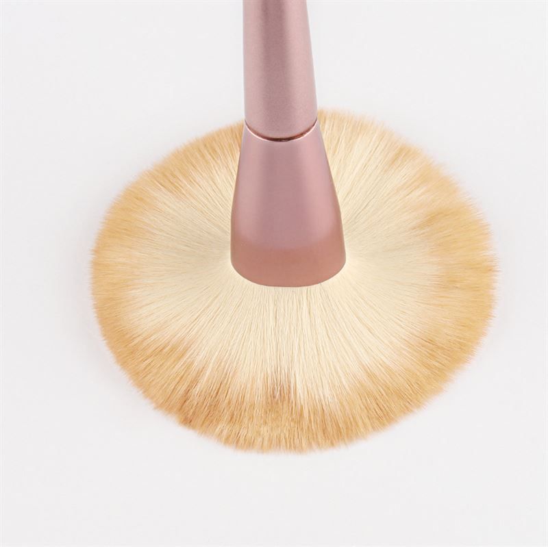 Pennello per trucco con manico rosa e setole chiare. Su sfondo bianco. Forma rotonda e ampia.