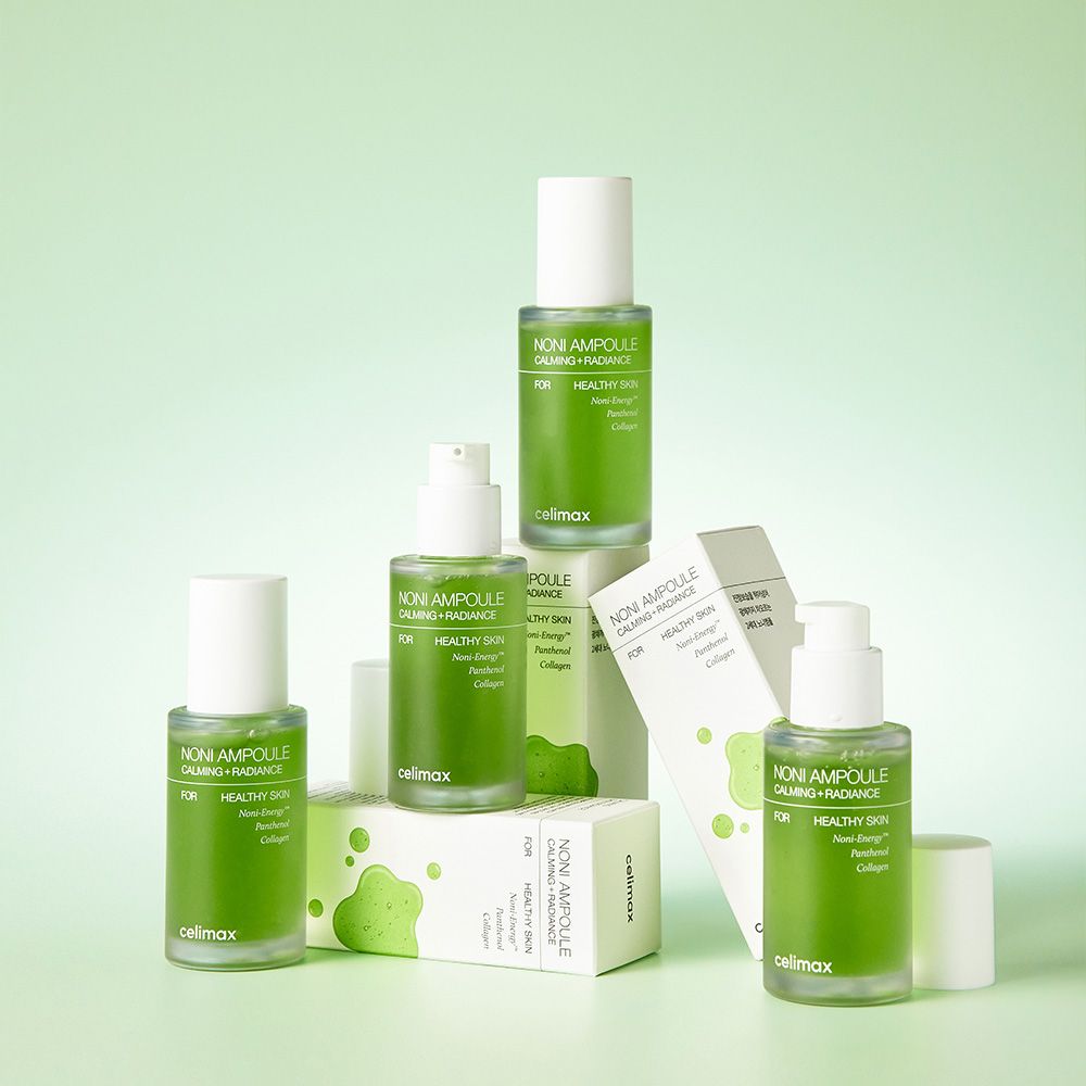 Diverse fiale e scatole Celimax Noni Energy su sfondo verde chiaro.