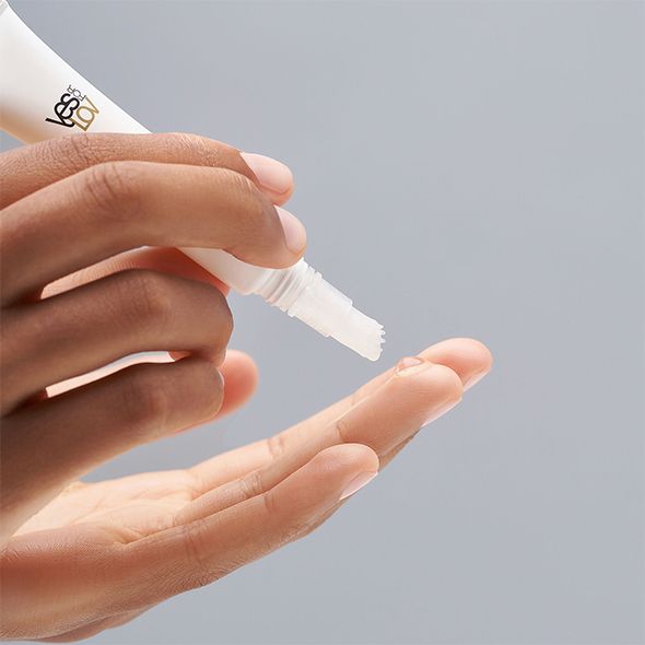 Prodotto in tubo bianco con applicatore. Applicazione sulla mano. Logo YESforLOV visibile.