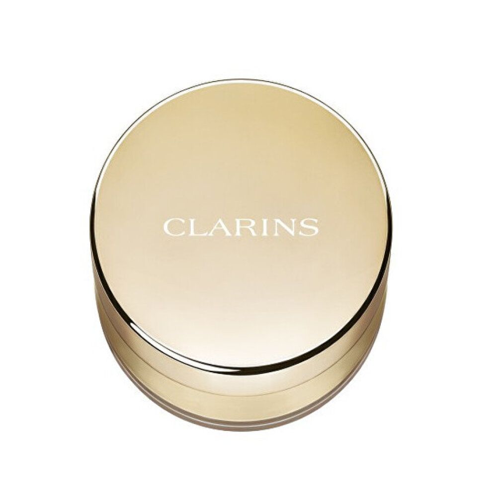 Cofanetto cipria chiuso. Coperchio dorato con scritta CLARINS. Forma rotonda.