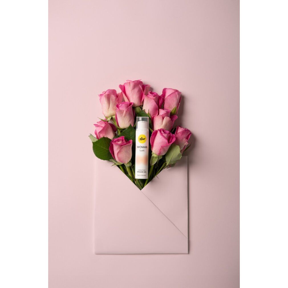 Prodotto in busta con rose. Flacone bianco con etichetta gialla. Nome e testo del prodotto. Testo: Vibrating Orgasm Gel. Sfondo rosa.